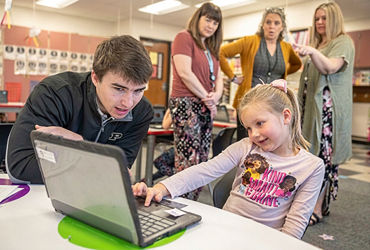 Kyczar showing kindergarden student how to use BabbleBot.